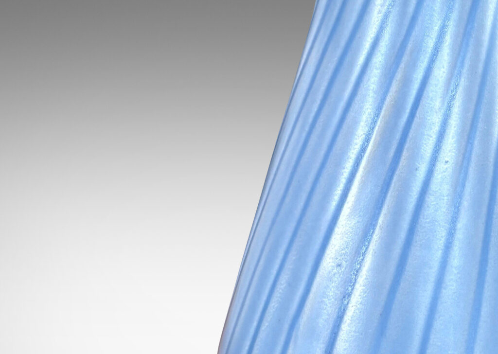 Gallery BAC swelling forms with swirled reeding and scalloped mouths, glazed in an eggshell finish light blue