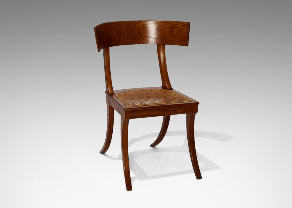 Gallery BAC curved back rail, springing sabered legs, and a hand-caned seat; solid oak