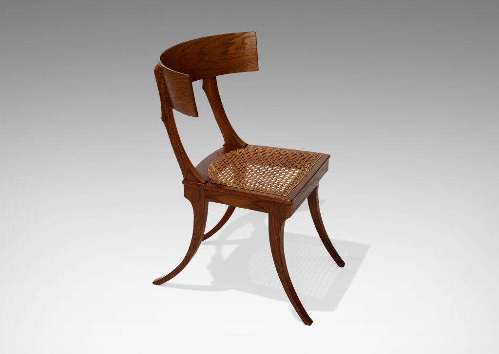 Gallery BAC curved back rail, springing sabered legs, and a hand-caned seat; solid oak