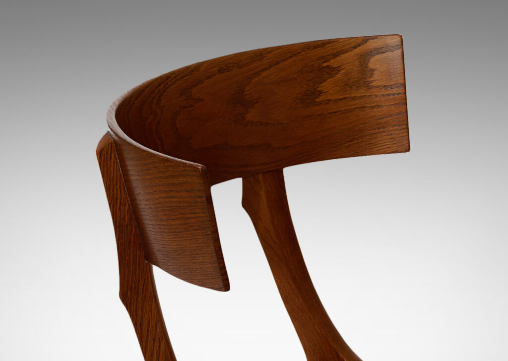 Gallery BAC curved back rail, springing sabered legs, and a hand-caned seat; solid oak