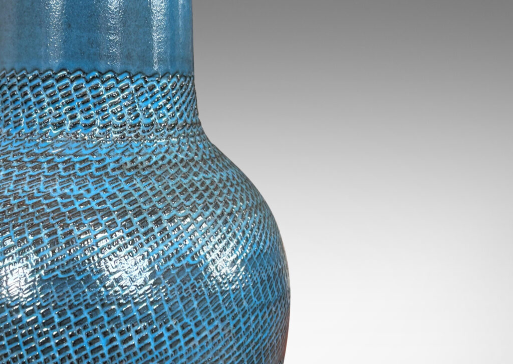 Gallery BAC tapered forms with wide necks and zig-zag texture, glazed in a light gray-blue with gray striae