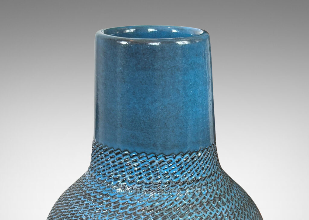 Gallery BAC tapered forms with wide necks and zig-zag texture, glazed in a light gray-blue with gray striae