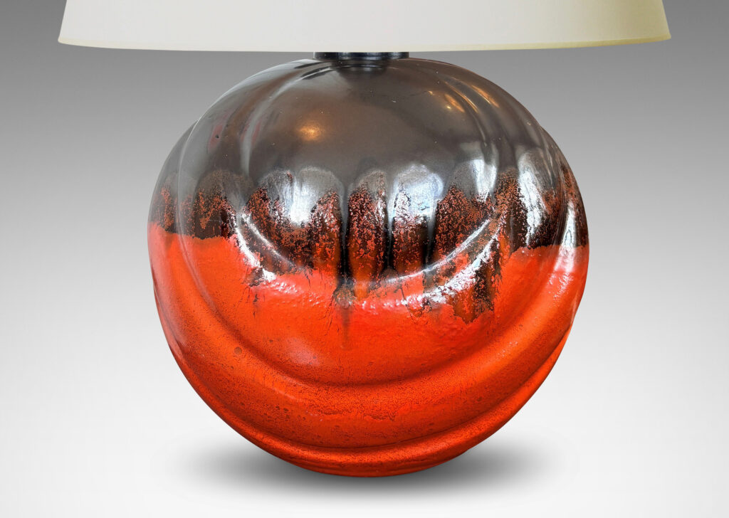 Gallery BAC diagonally lobed globe form, glazed orange overglazed on top with gunmetal gray