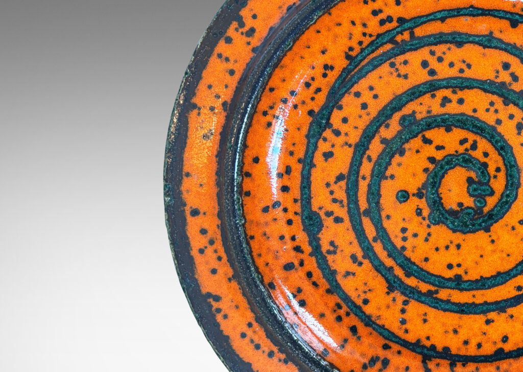 Gallery BAC low profile with wide articulated lip, glazed in black speckled orange, with black spiral design