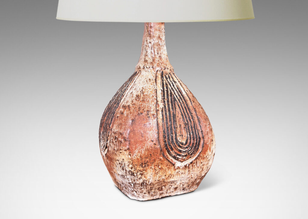 Gallery BAC squared bulb form with attenuated neck and carved concentric drop design, glazed in pale gray-tan and brown
