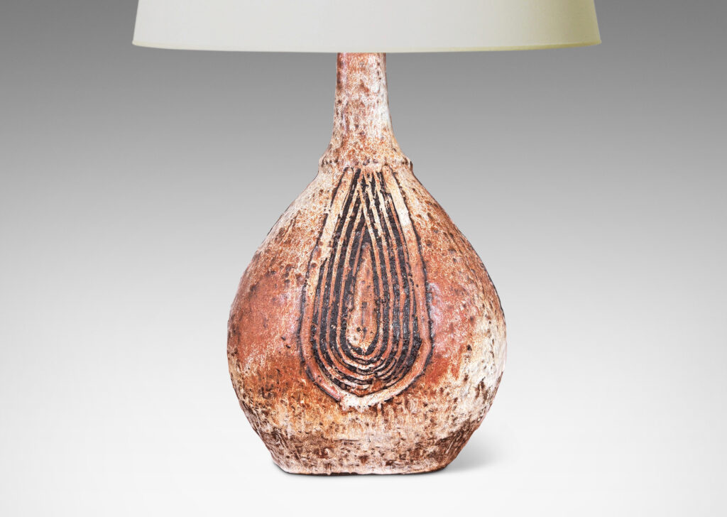 Gallery BAC squared bulb form with attenuated neck and carved concentric drop design, glazed in pale gray-tan and brown