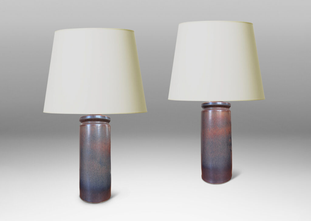 Gallery BAC cylindrical forms with exotic capped tops, glazed in a dark brown harefur