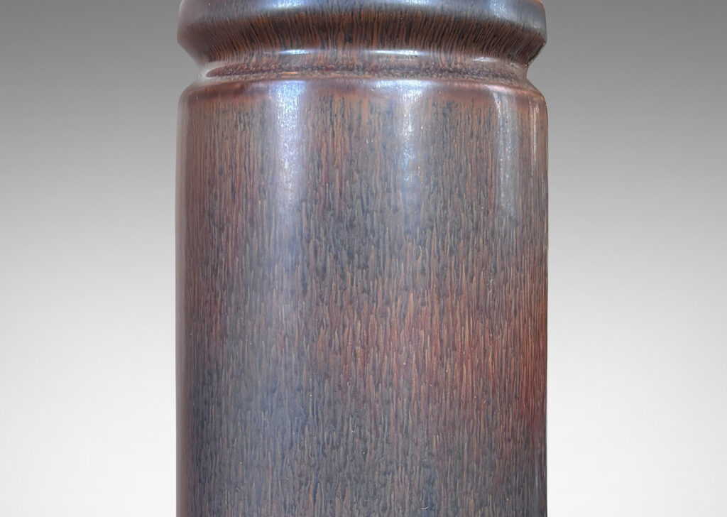 Gallery BAC cylindrical forms with exotic capped tops, glazed in a dark brown harefur