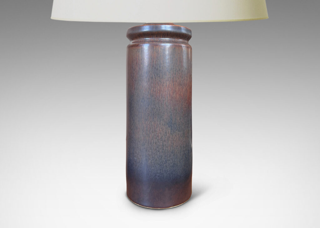 Gallery BAC cylindrical forms with exotic capped tops, glazed in a dark brown harefur