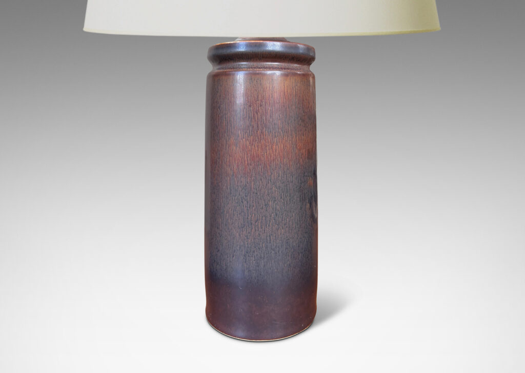 Gallery BAC cylindrical forms with exotic capped tops, glazed in a dark brown harefur