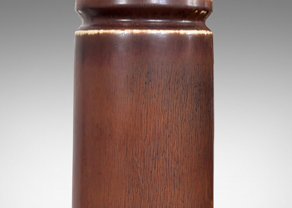 Gallery BAC cylindrical forms with exotic capped tops, glazed in a warm medium brown harefur