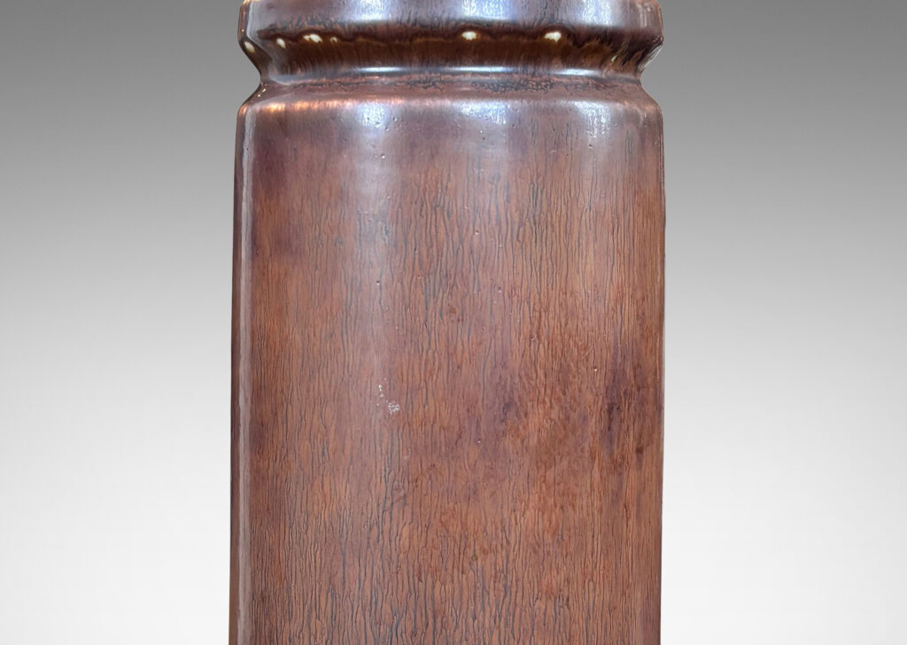 Gallery BAC cylindrical forms with exotic capped tops, glazed in a warm medium brown harefur