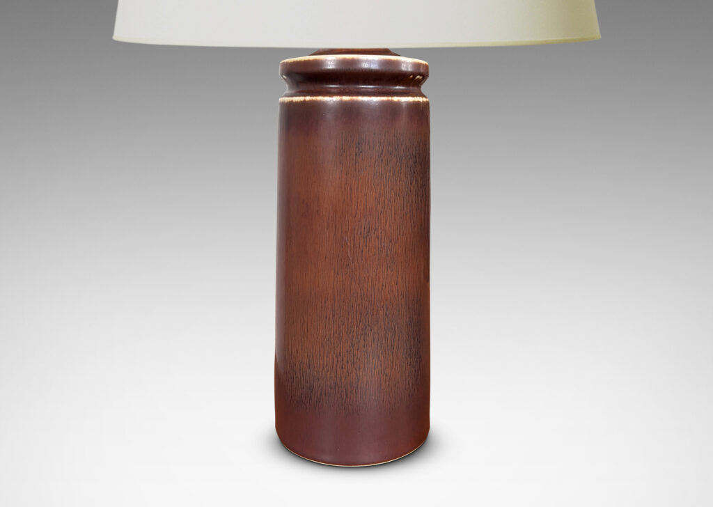 Gallery BAC cylindrical forms with exotic capped tops, glazed in a warm medium brown harefur