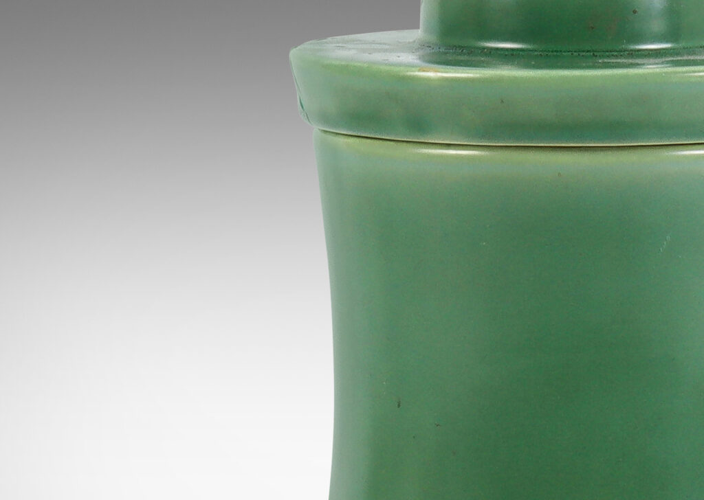 Gallery BAC concave-sided cylindrical form, with stepped lid and stem finial, glazed in a jade green tone