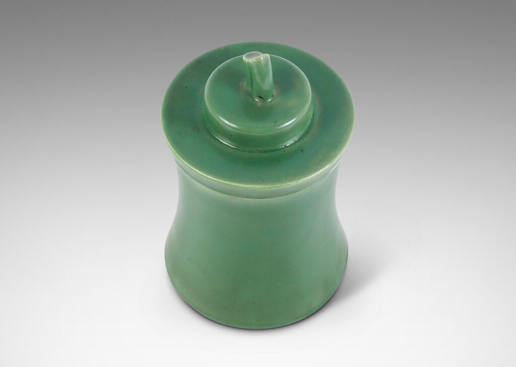 Gallery BAC concave-sided cylindrical form, with stepped lid and stem finial, glazed in a jade green tone