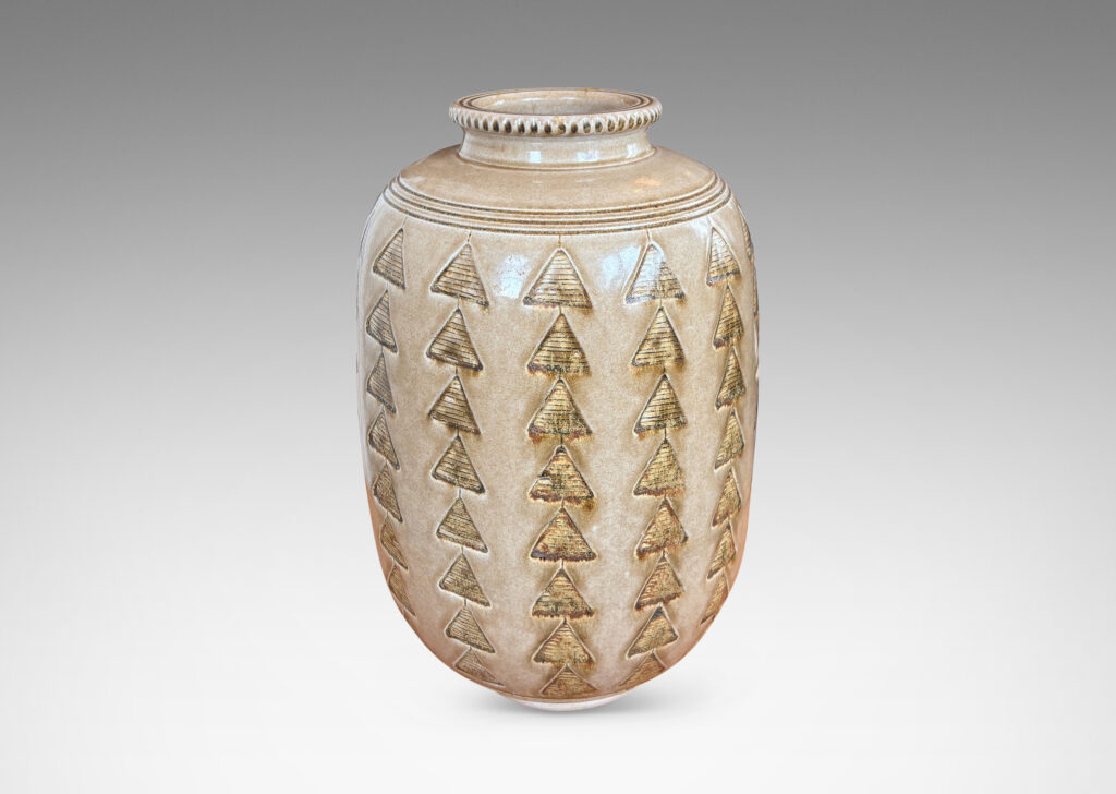Gallery BAC large upright ovoid form decorated with carved rings and impressed triangle motifs, glazed in a pale topaz-brown