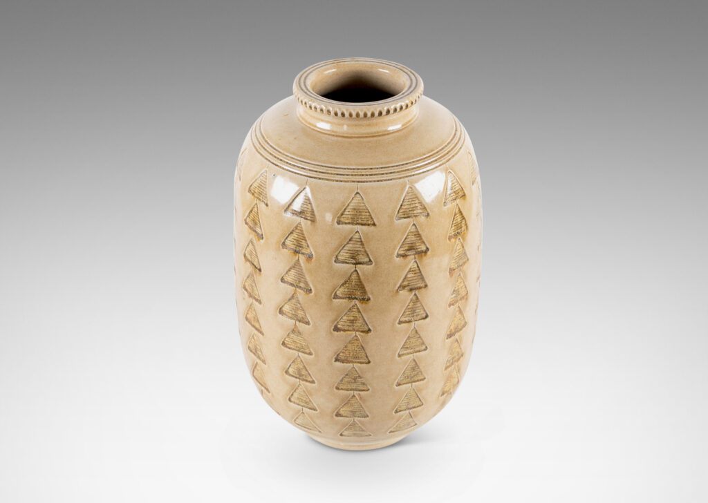 Gallery BAC large upright ovoid form decorated with carved rings and impressed triangle motifs, glazed in a pale topaz-brown