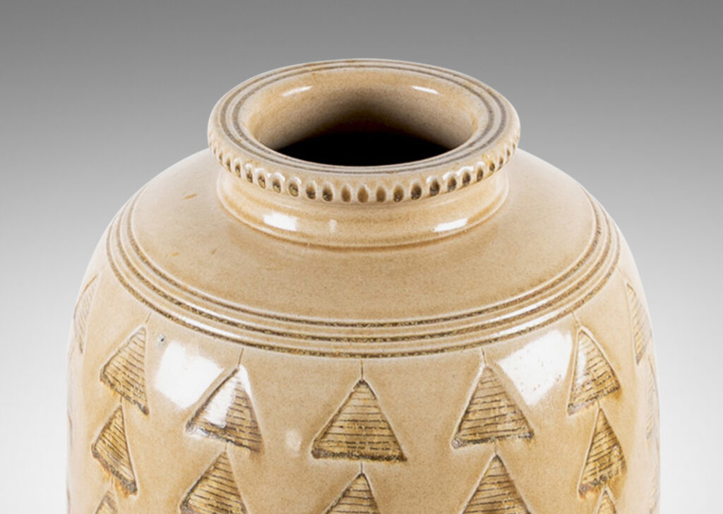 Gallery BAC large upright ovoid form decorated with carved rings and impressed triangle motifs, glazed in a pale topaz-brown