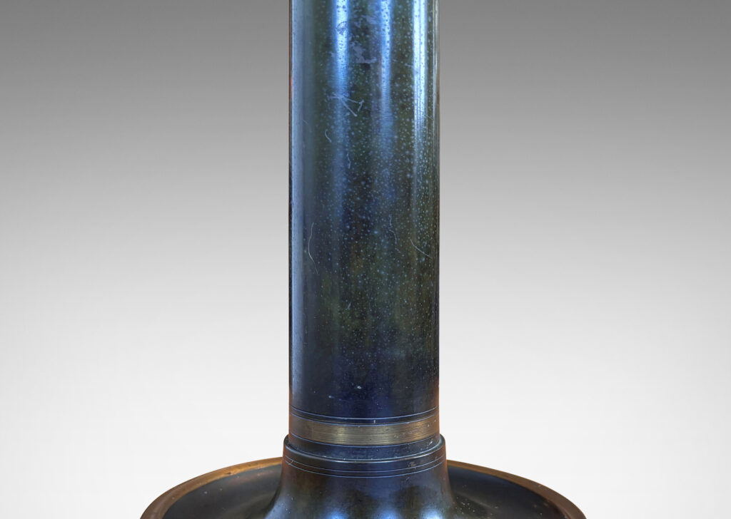 Gallery BAC columnar stand with cavetto cap, on a coved disk base, with handsome original patination articulated wit polished bands; bronze