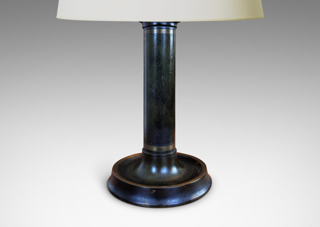 Gallery BAC columnar stand with cavetto cap, on a coved disk base, with handsome original patination articulated wit polished bands; bronze