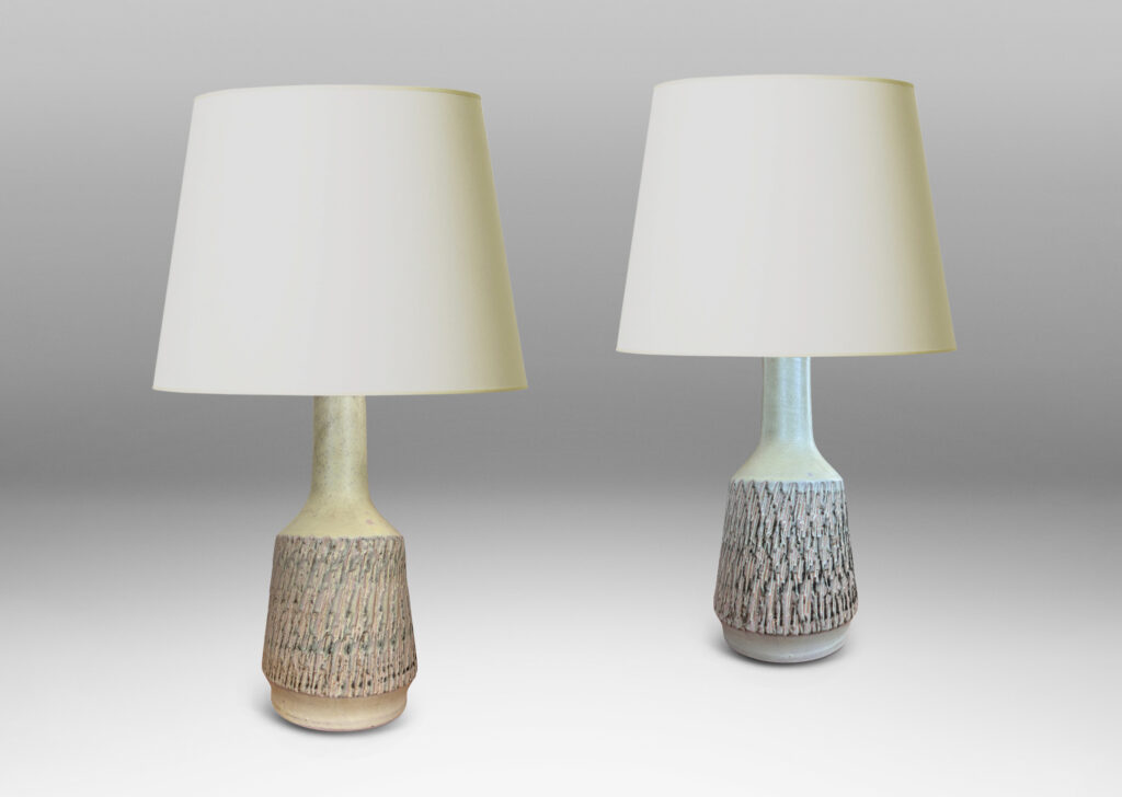 Gallery BAC flared drum forms with rustically textured sides and tall necks, glazed in a matte pale khaki tone; earthenware