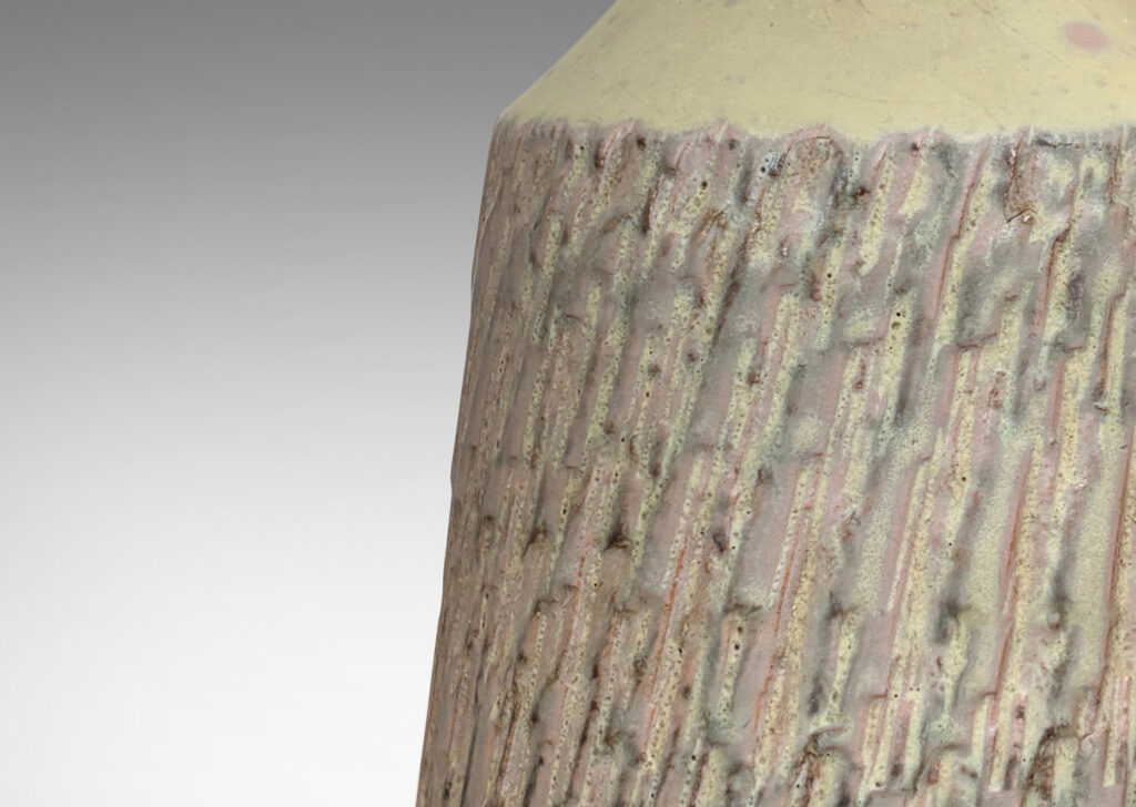 Gallery BAC flared drum forms with rustically textured sides and tall necks, glazed in a matte pale khaki tone; earthenware