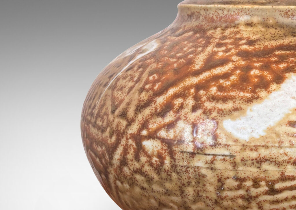 Gallery BAC compressed globe form with notch-articulated mouth, glazed in golden-tan with ivory brushstrokes encircling shoulder