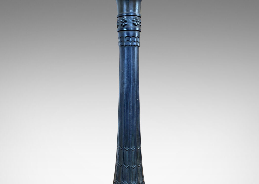 Gallery BAC cove-sided triangular base, with flared column wrapped in scale, palmate and rosette ornaments