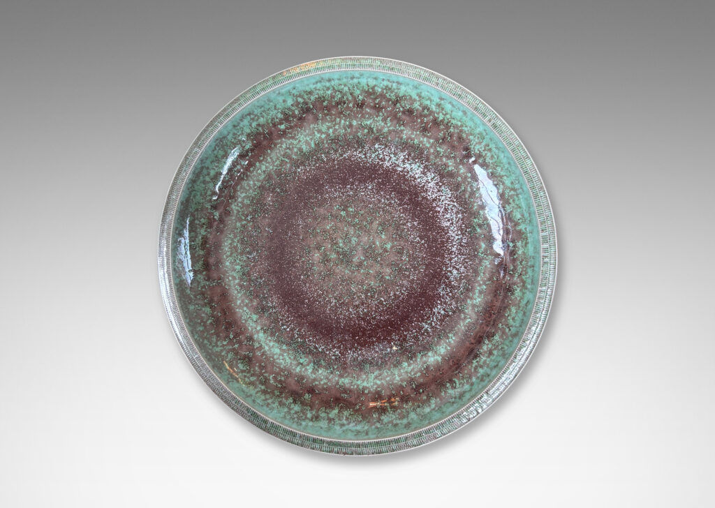 Gallery BAC beautifully sculpted wide shallow form with lip finished in carved hatch marks and a marvelous oxblood-celadon glaze