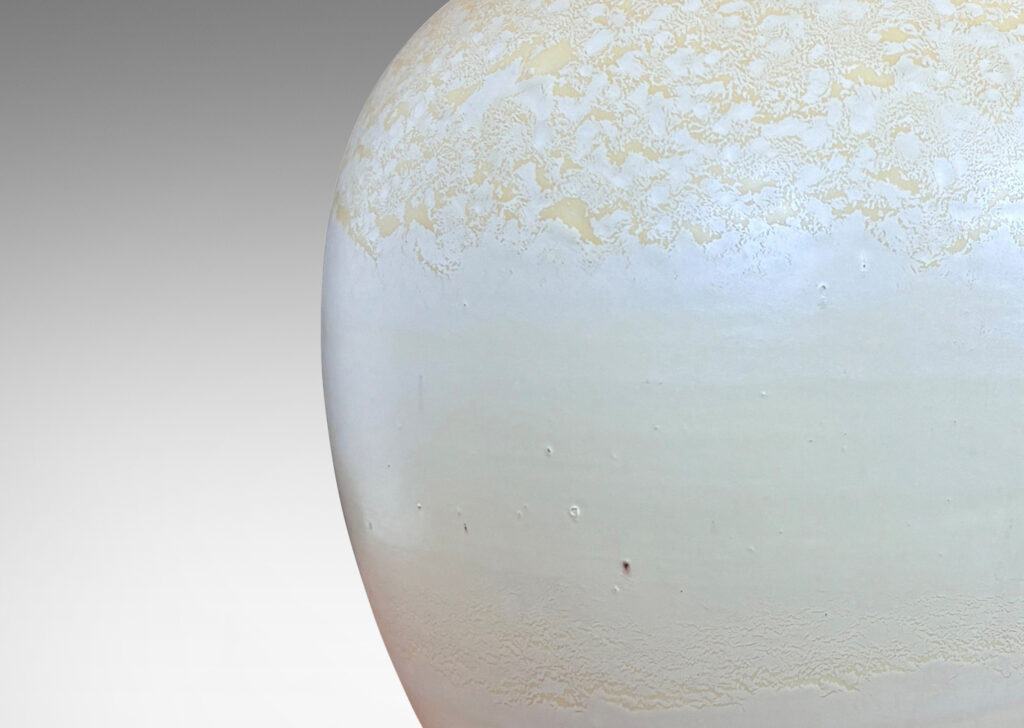 Gallery BAC softly modeled balloon-like form with dome lid and spherical finial, glazed in a pale yellow-ivory