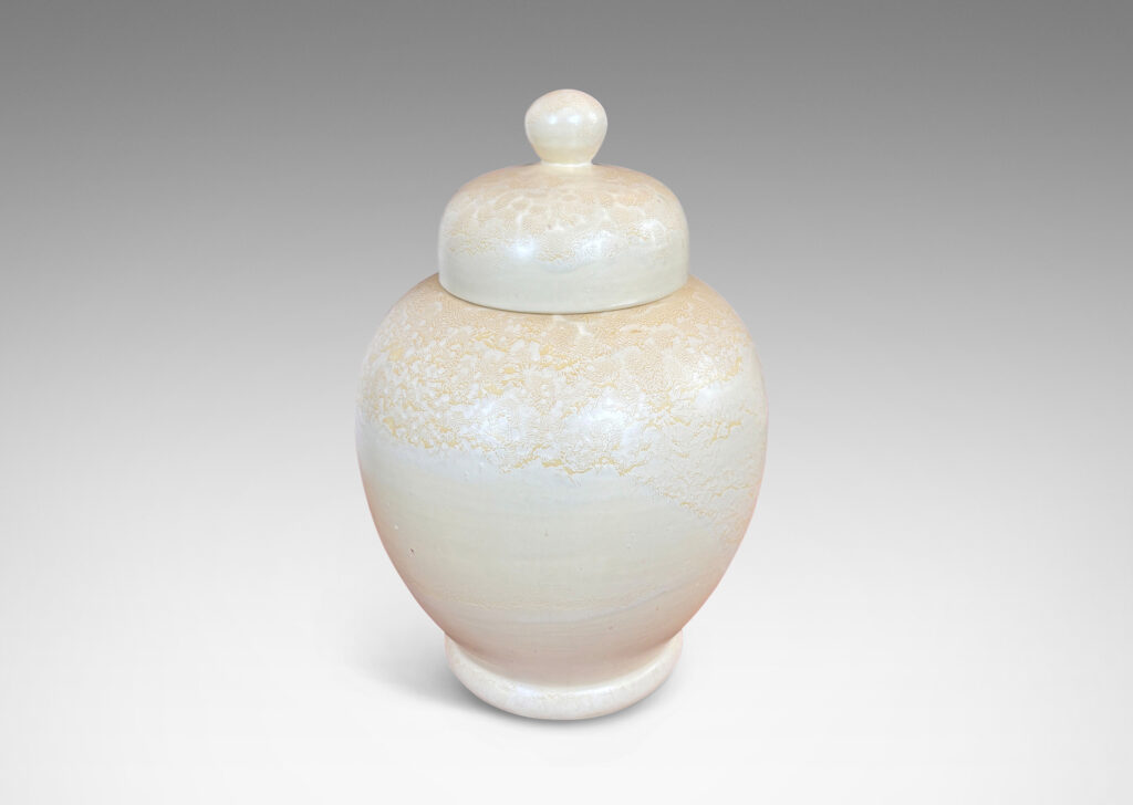 Gallery BAC softly modeled balloon-like form with dome lid and spherical finial, glazed in a pale yellow-ivory