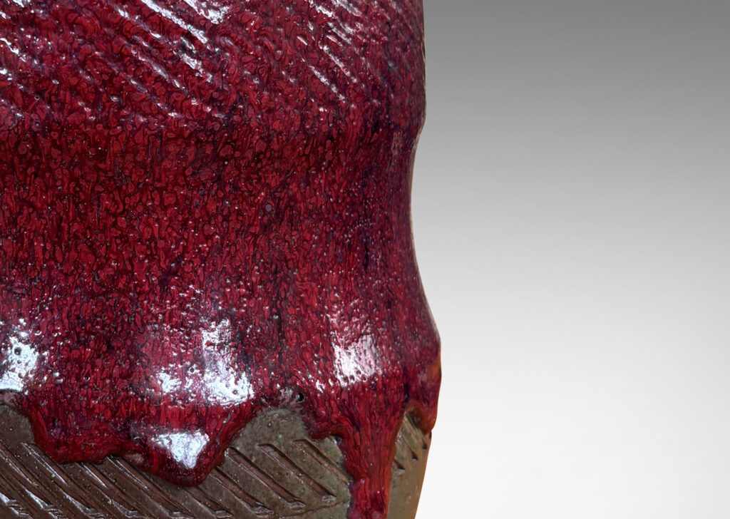 Gallery BAC cinched form with carved diagonals, glazed in thick flowing oxblood burgundy over blue-brown