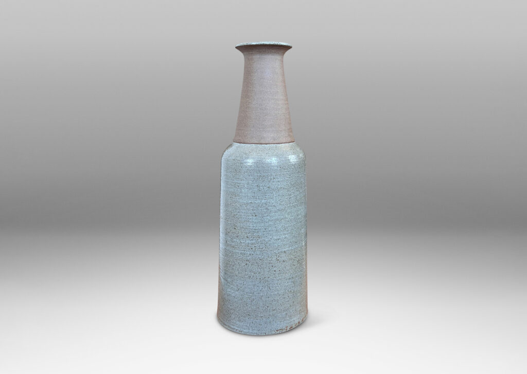 Gallery BAC cylindrical body, conical neck, and outstretched mouth, glazed in gray and matte brown