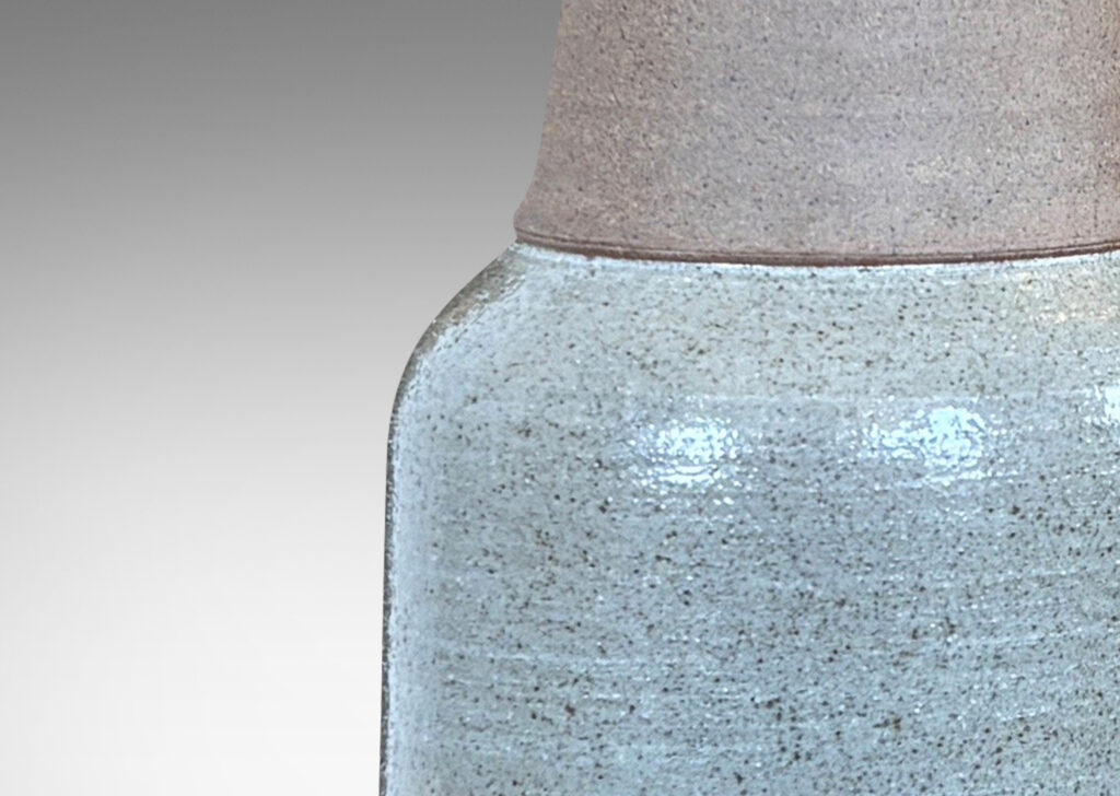 Gallery BAC cylindrical body, conical neck, and outstretched mouth, glazed in gray and matte brown