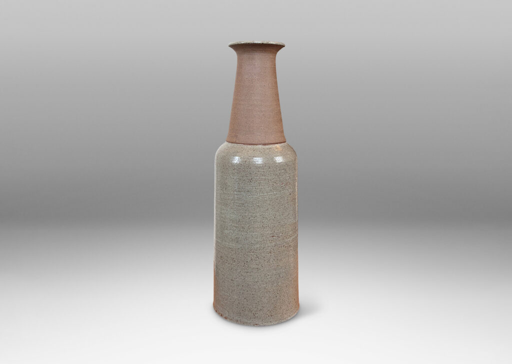 Gallery BAC cylindrical body, conical neck, and outstretched mouth, glazed in gray and matte brown