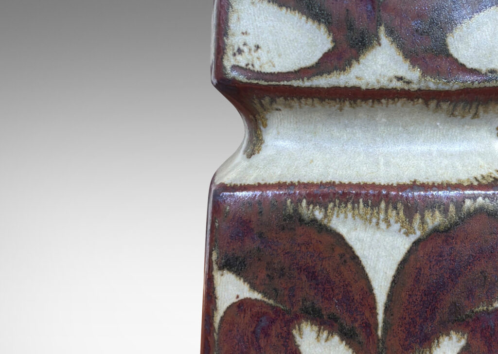Gallery BAC tiered squared form, glazed in a pale warm gray with foliate motifs in rust luster