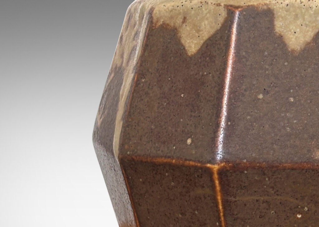 Gallery BAC angled and faceted form glazed in pale taupe-brown, with silver plated lid topped by a foliate finial