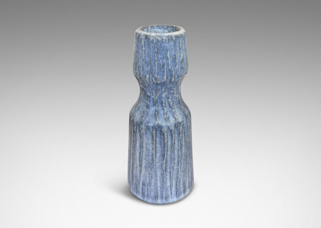 Gallery BAC notched form and another with a conical neck on a spherical body, both with carved surfaces glazed in a pale gray-blue