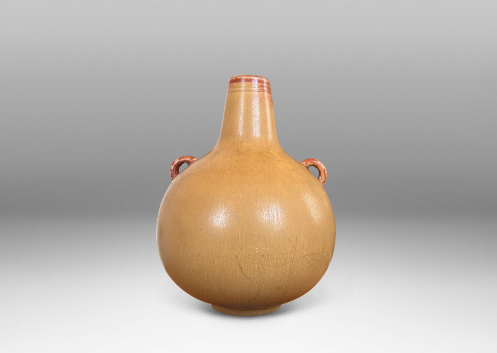 Gallery BAC globe form with sprouting neck and pair of ear-form handles, glazed in a flowing ochre tan-burnt sienna