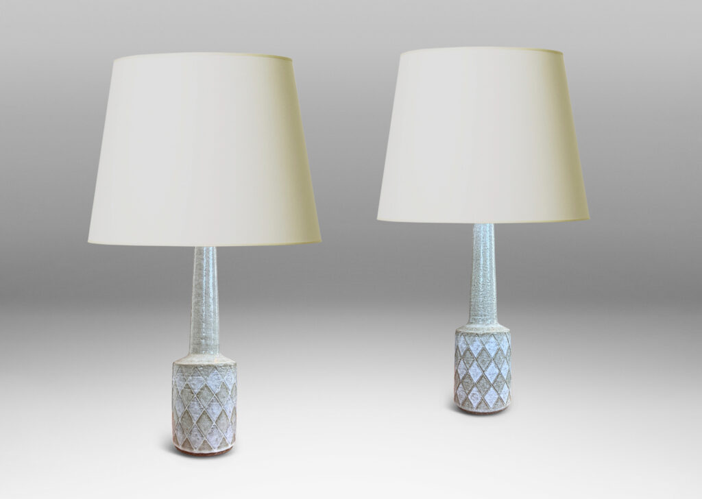 Gallery BAC drum form with carved harlequin design, and tall conical neck, glazed in pale gray with some diamond motifs in white