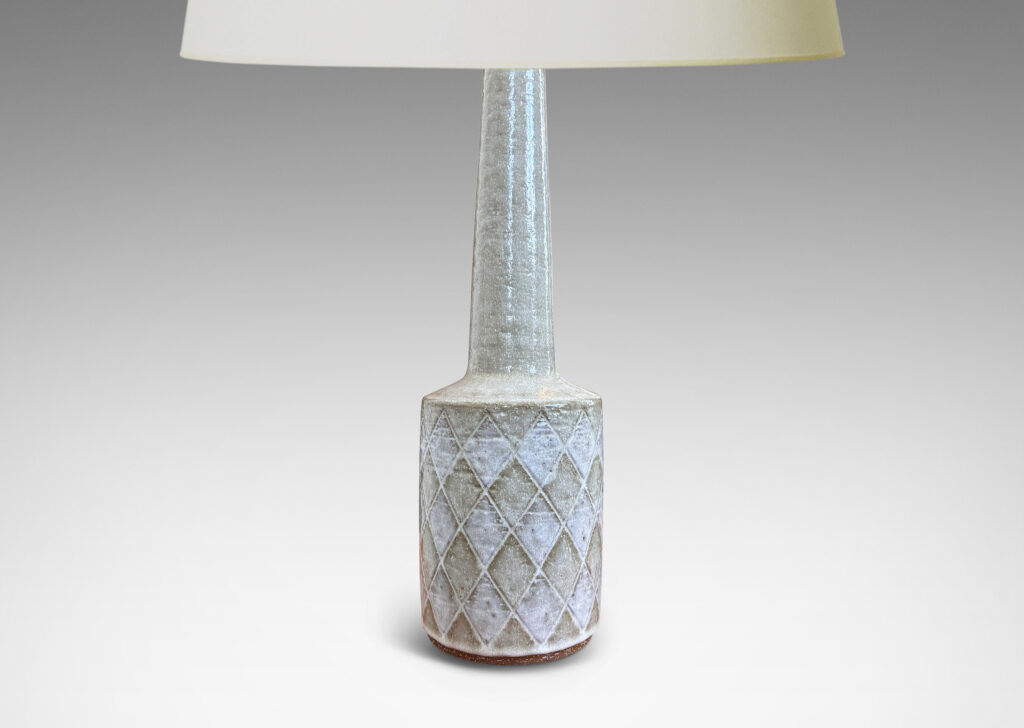 Gallery BAC drum form with carved harlequin design, and tall conical neck, glazed in pale gray with some diamond motifs in white