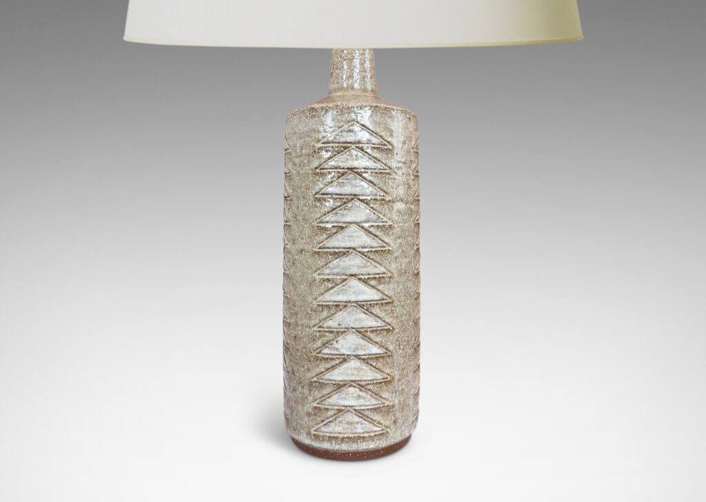 Gallery BAC cylindrical form with columns of carved triangle motifs, glazed in pale gray and white