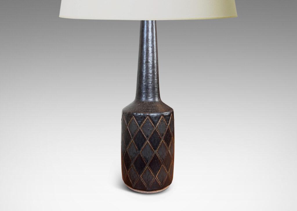 Gallery BAC drum form with carved harlequin design, and tall conical neck, glazed in eggshell brown with some diamond motifs finished in matte