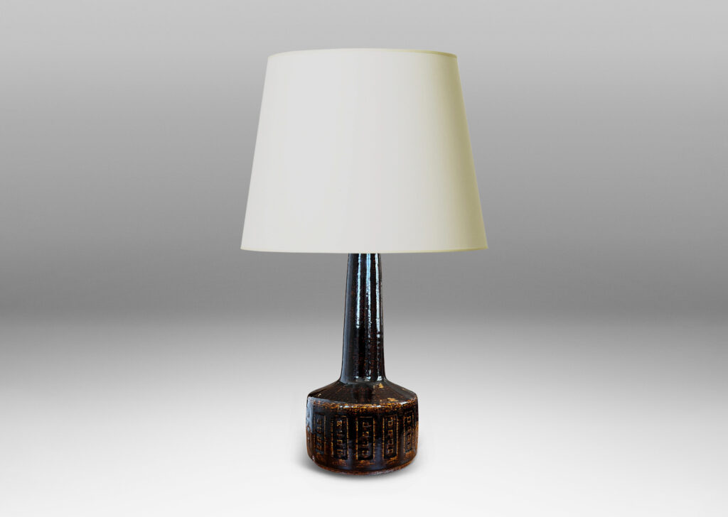 Gallery BAC low drum form with carved geometric design and tall neck, glazed in a dark brown