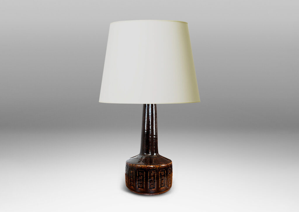 Gallery BAC low drum form with carved geometric design and tall neck, glazed in a dark brown