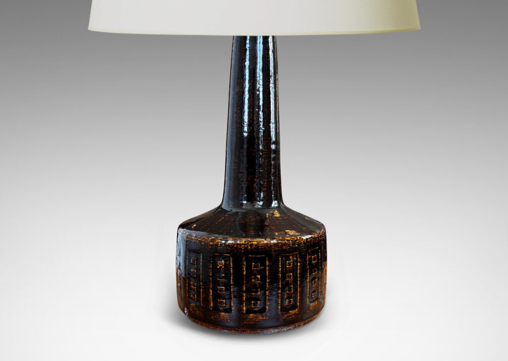 Gallery BAC low drum form with carved geometric design and tall neck, glazed in a dark brown