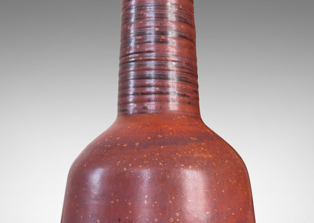 Gallery BAC gumdrop-like three-quarters ovoid form with tall ridged neck, glazed in a rich warm burnt sienna brown