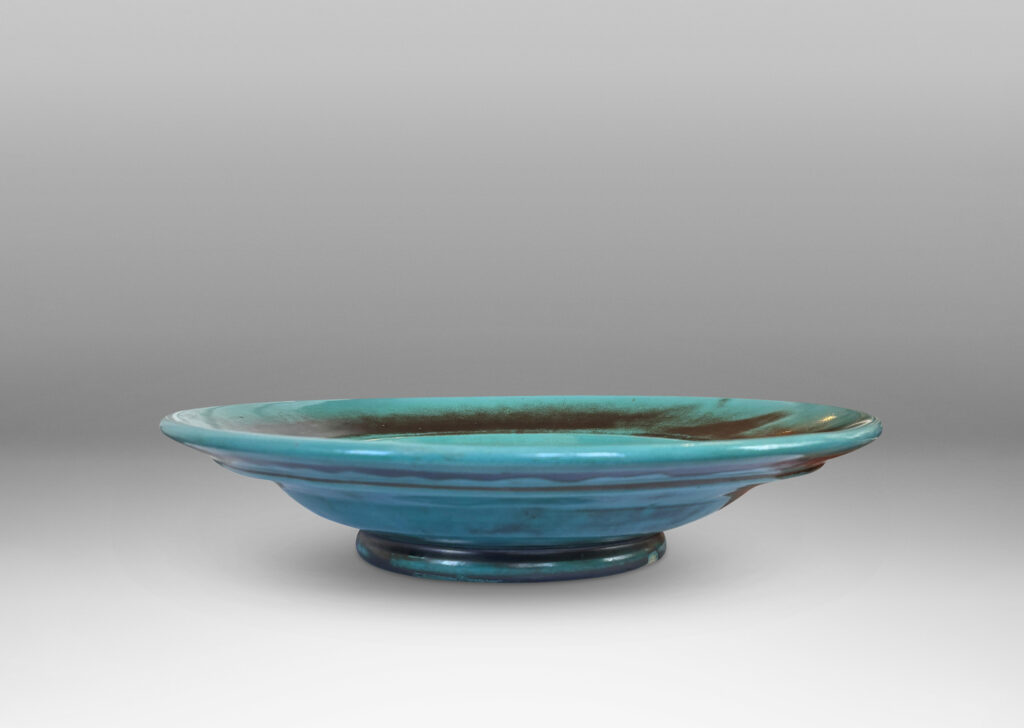 Gallery BAC nverted dome center with wide angled border, glazed in the pottery’s signature cerulean-green and metallic gray-blue