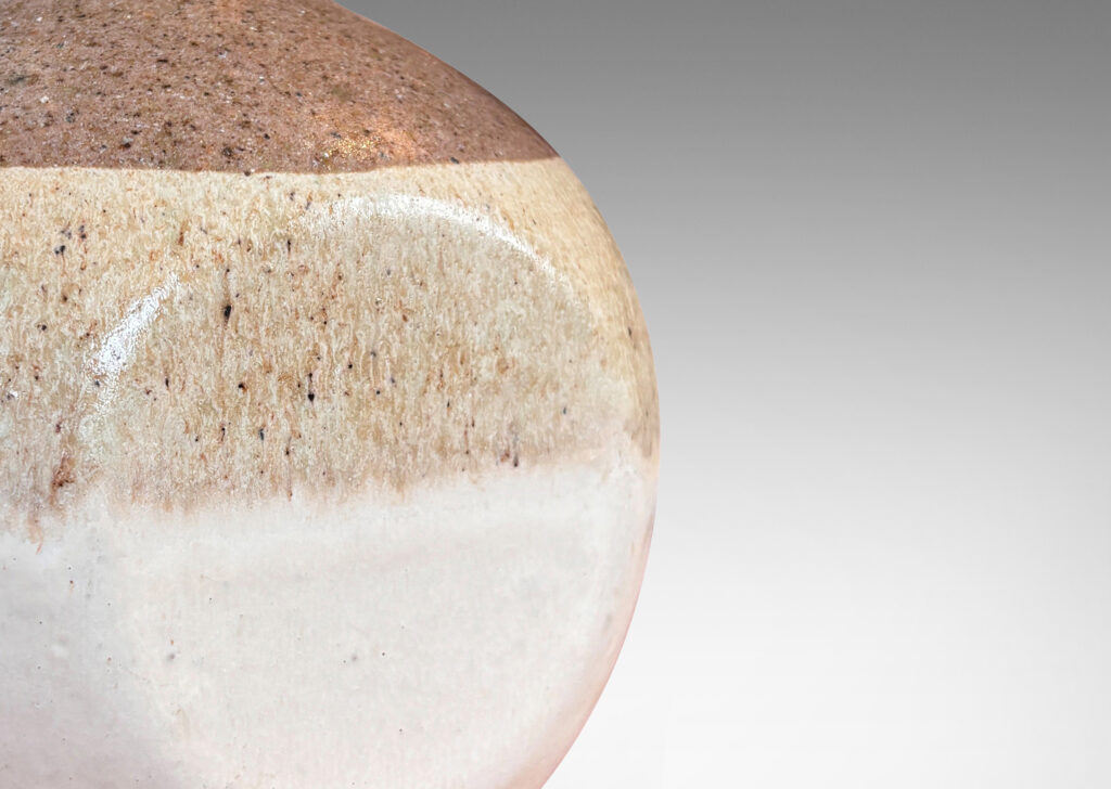 Gallery BAC spherical form squared with four flattened sides, in speckled gray, with speckled tan and ivory glazes