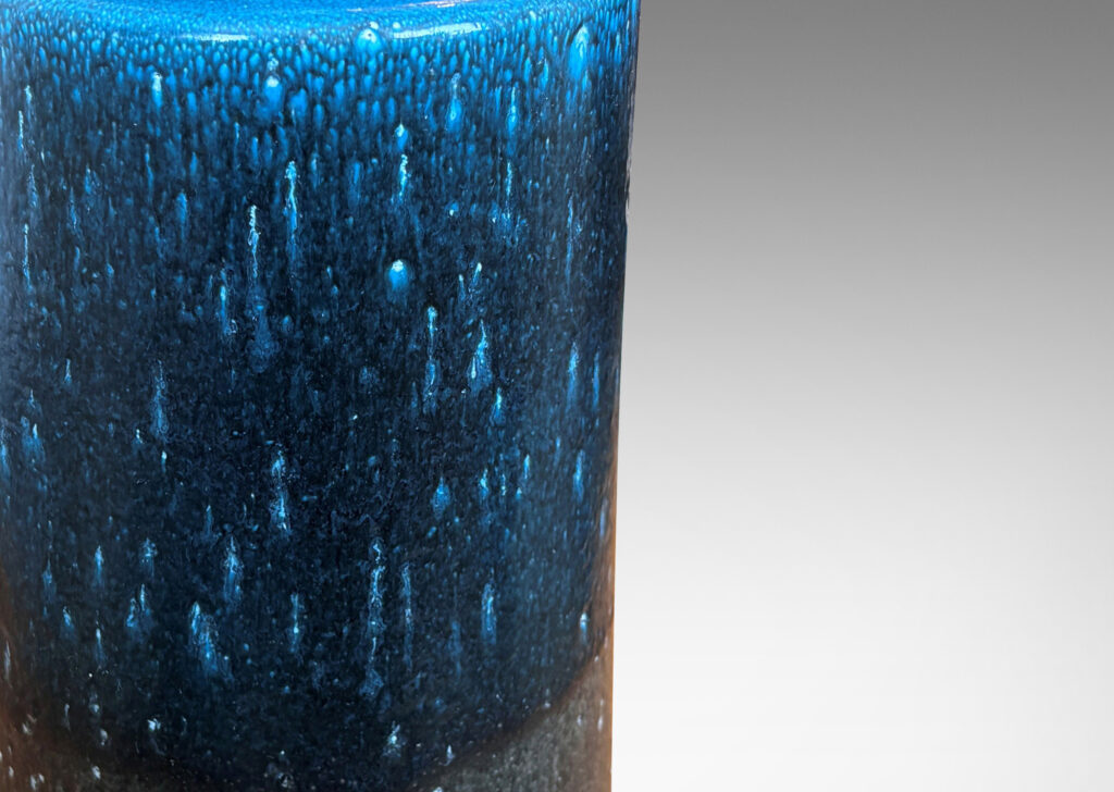 Gallery BAC chunky cylindrical form, glazed in a speckled cerulean over dark gray
